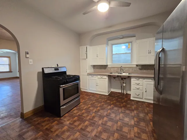 a kitchen with stainless steel appliances granite countertop a stove a sink and a refrigerator