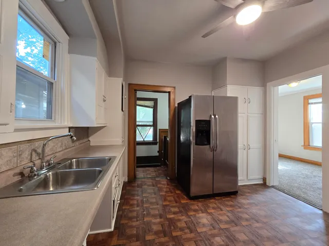 a kitchen with stainless steel appliances granite countertop a refrigerator and a sink