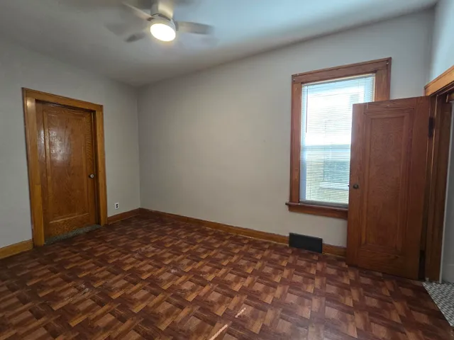 an empty room with windows and closet