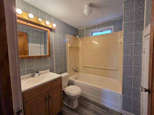 a bathroom with a sink mirror toilet and shower