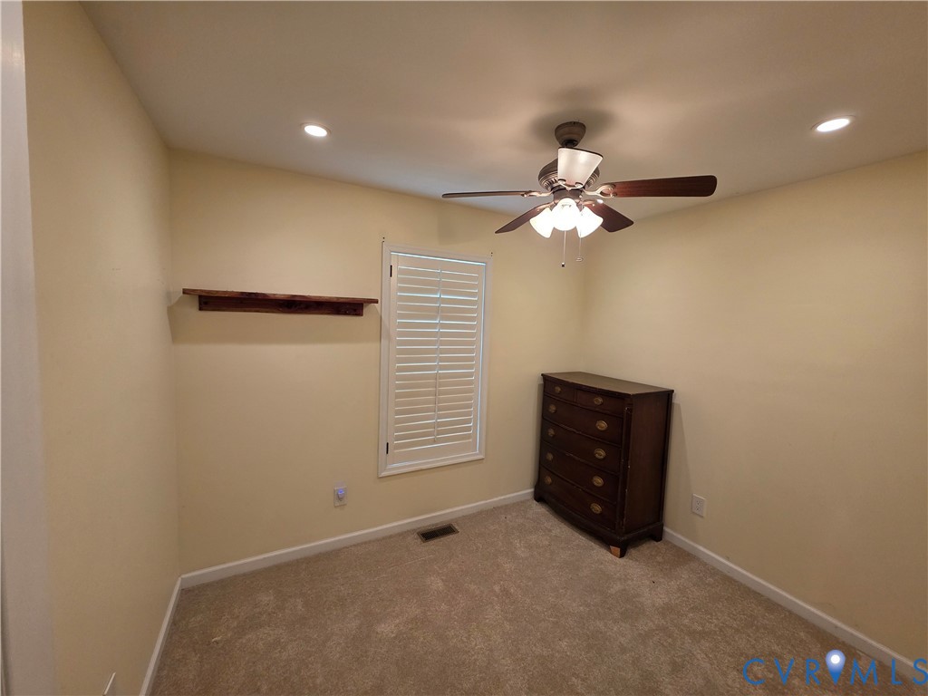 416 Berry Hill Road Tappahannock, VA 22560 - Photo 8 of 18 an empty room with closet and a chandelier fan