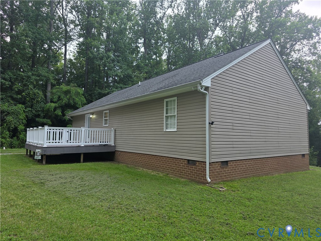 416 Berry Hill Road Tappahannock, VA 22560 - Photo 10 of 18 a view of a house with a backyard and wooden deck