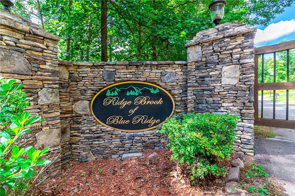 Lot 22 Meadow Brook Trail Morganton, GA 30560 - Photo 2 of 51 a sign that is sitting on a brick wall