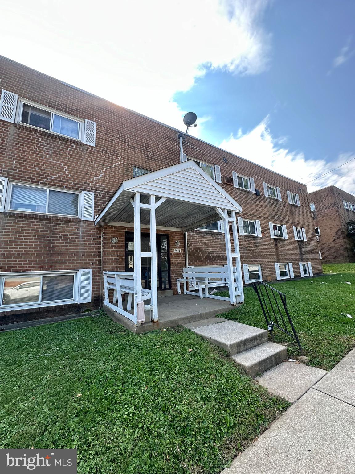 7913 Dungan Road, Unit 1B Philadelphia, PA 19111 - Photo 13 of 14 a view of a house with a yard and sitting area