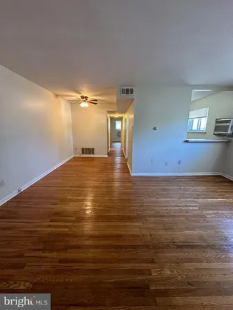a view of a room with wooden floor