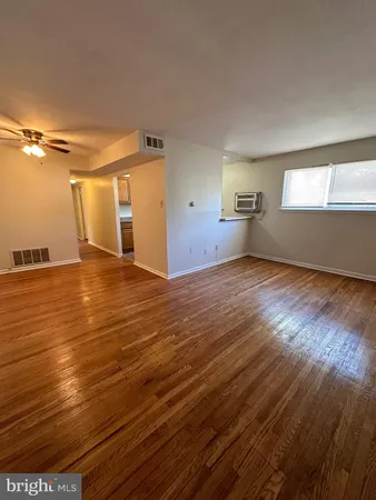 a view of a room with wooden floor