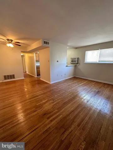 a view of a room with wooden floor