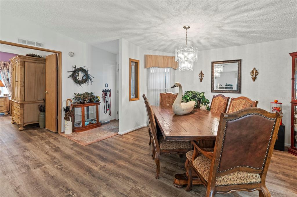 83 Eagle Circle Ellenton, FL 34222 - Photo 10 of 60 a view of a dining room with furniture and a chandelier
