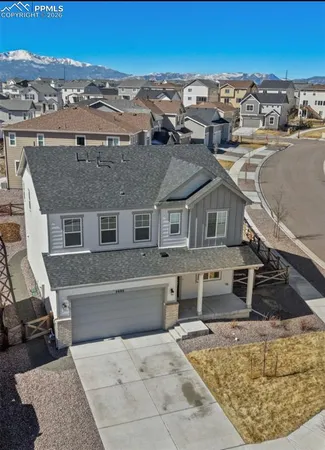an aerial view of a house with a yard