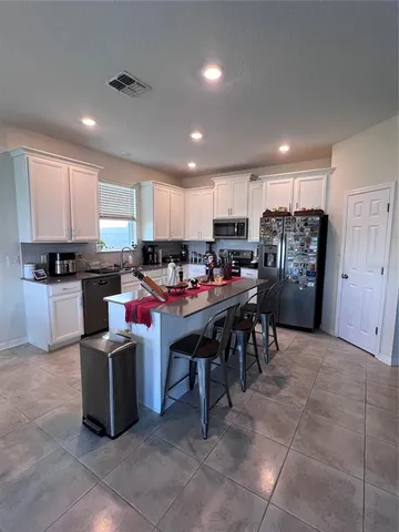 a kitchen with a cabinets and refrigerator
