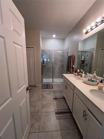a large bathroom with a double vanity sink a and a mirror