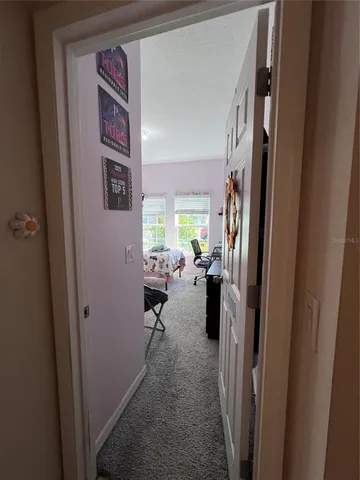 a view of a hallway with couch and closet