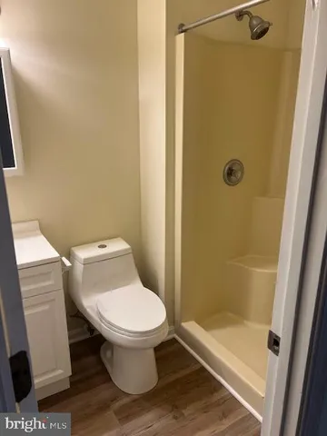 a bathroom with a toilet and a shower