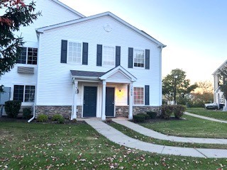 1309 Silverstone Drive, Unit 1309 Carpentersville, IL 60110 - Photo 1 of 12 a front view of a house with a yard and trees