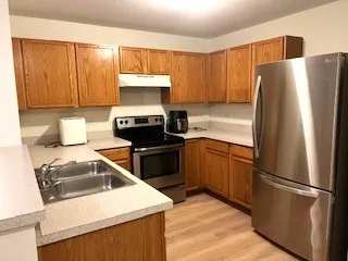 a kitchen with a refrigerator sink and stove top oven