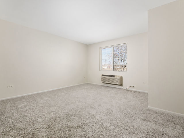 1309 Silverstone Drive, Unit 1309 Carpentersville, IL 60110 - Photo 11 of 12 an empty room with windows