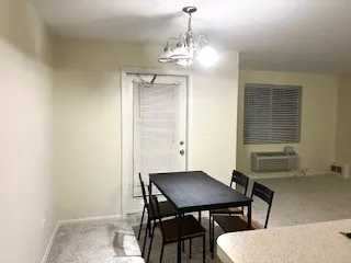 a view of a dining room with furniture and window