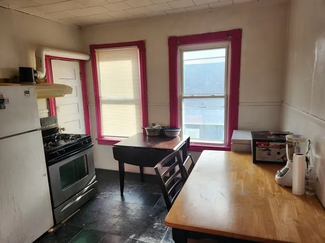 a kitchen with stainless steel appliances a stove a sink and a refrigerator