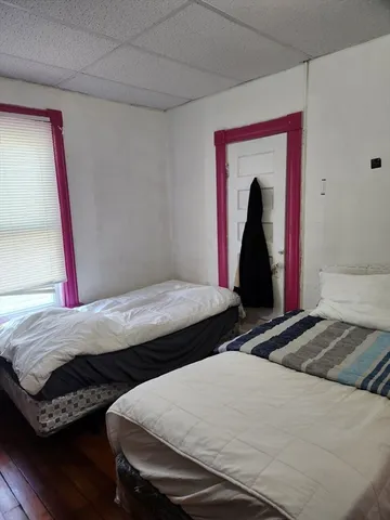 a bedroom with a bed and a mirror