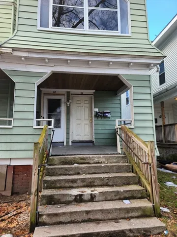 a view of a patio with a table and chairs