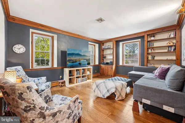 a spacious bedroom with a bed couch and a large window