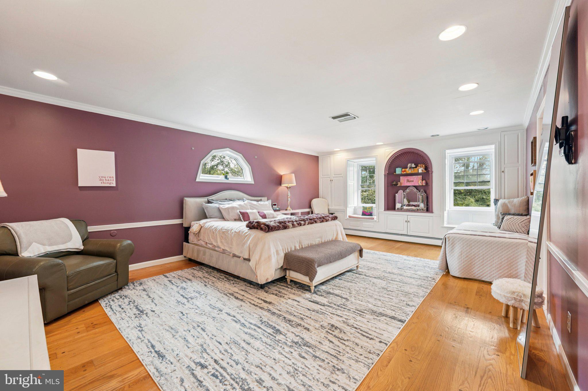 1535 Scrope Road Rydal, PA 19046 - Photo 28 of 63 a spacious bedroom with a bed couch and a large window