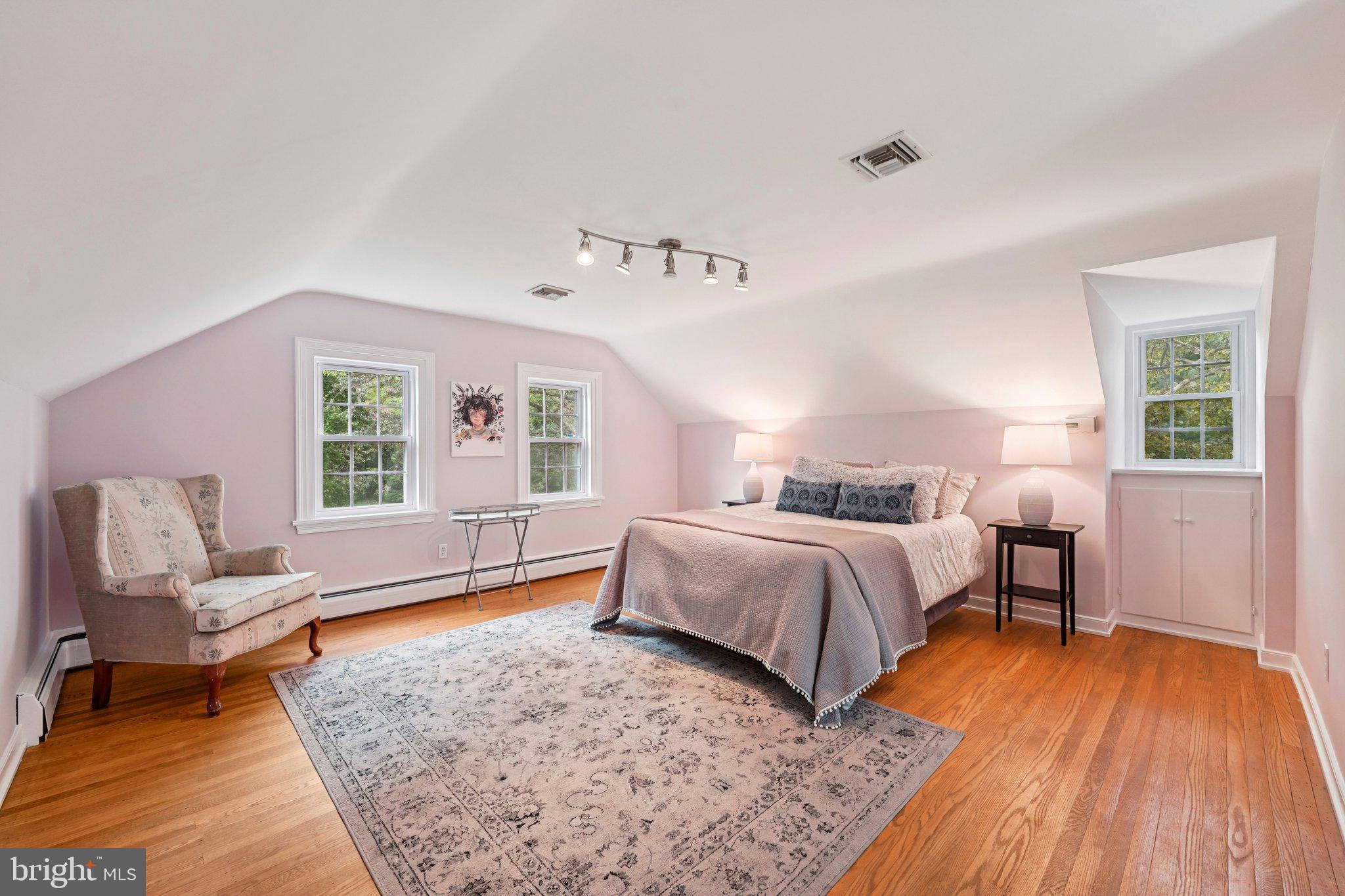 1535 Scrope Road Rydal, PA 19046 - Photo 35 of 63 a spacious bedroom with a bed and wooden floor