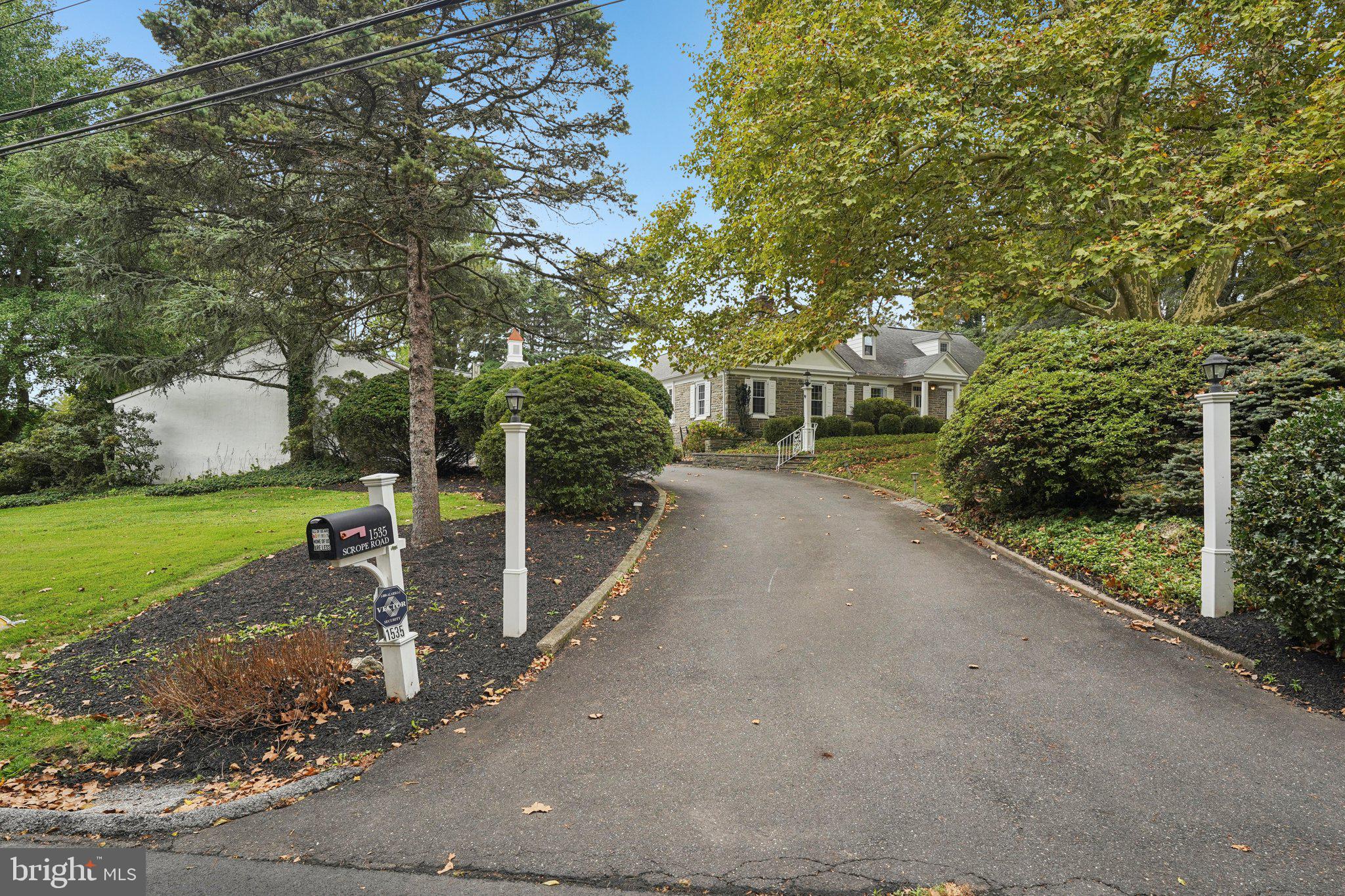 1535 Scrope Road Rydal, PA 19046 - Photo 59 of 63 a view of a street with a bench and trees