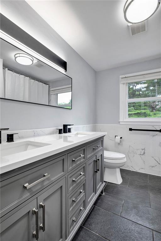 113 Duncan Circle Beaver, PA 15009 - Photo 37 of 44 a spacious bathroom with a double vanity sink a toilet and a mirror