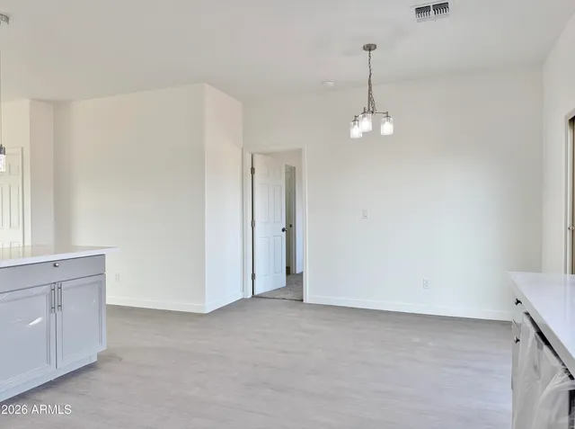 a view of a chandelier in big room and chandelier