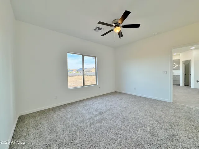an empty room with closet and windows
