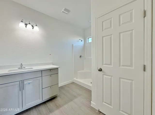 a bathroom with a double vanity sink and mirror