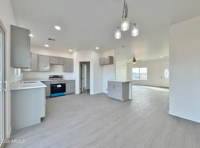 a view of a kitchen with a sink and a stove top oven