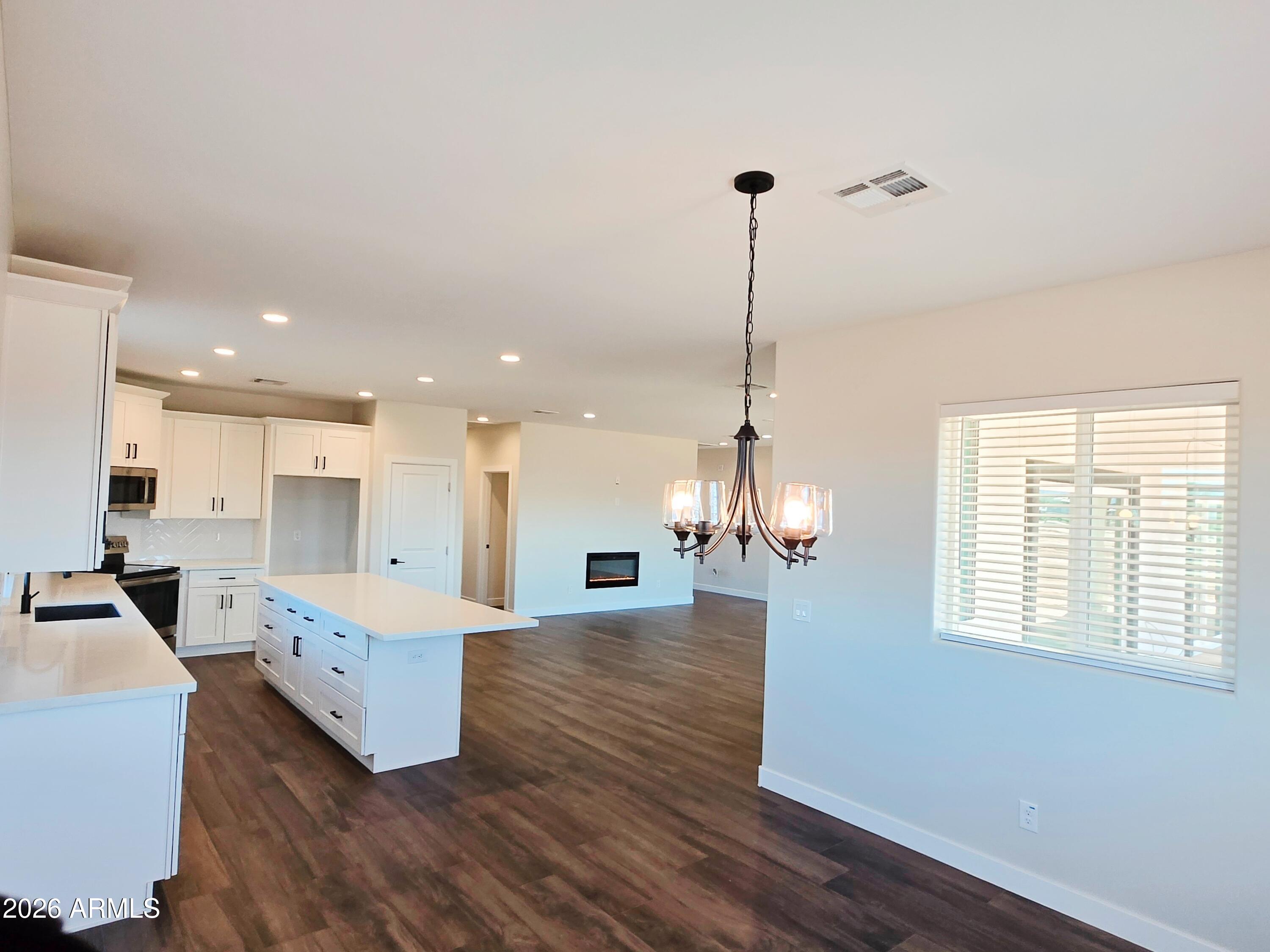 20735 West Elliot Road Buckeye, AZ 85326 - Photo 15 of 59 a large kitchen with sink a refrigerator and wooden floor