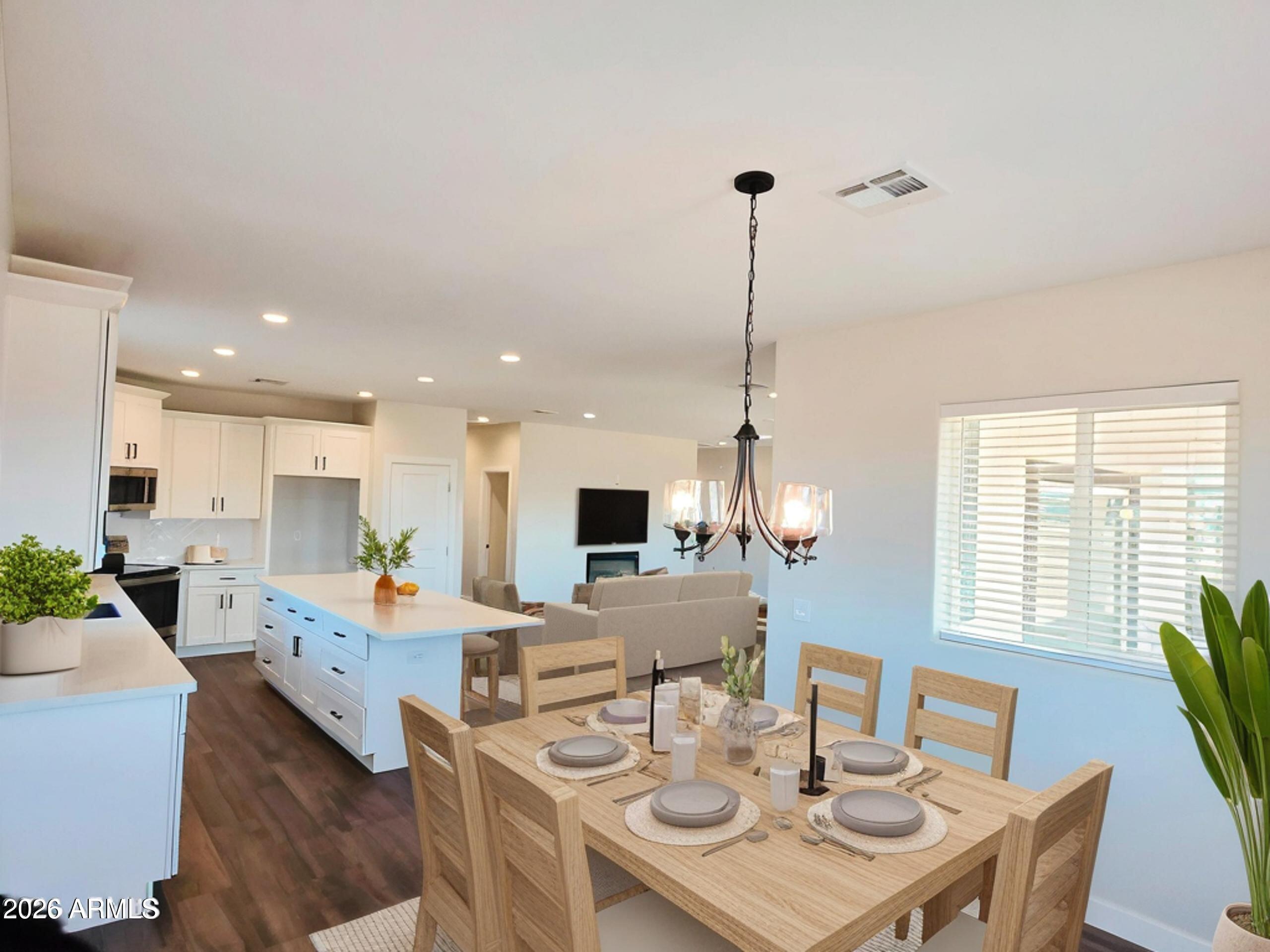 20735 West Elliot Road Buckeye, AZ 85326 - Photo 16 of 59 a view of a dining room with furniture window and wooden floor