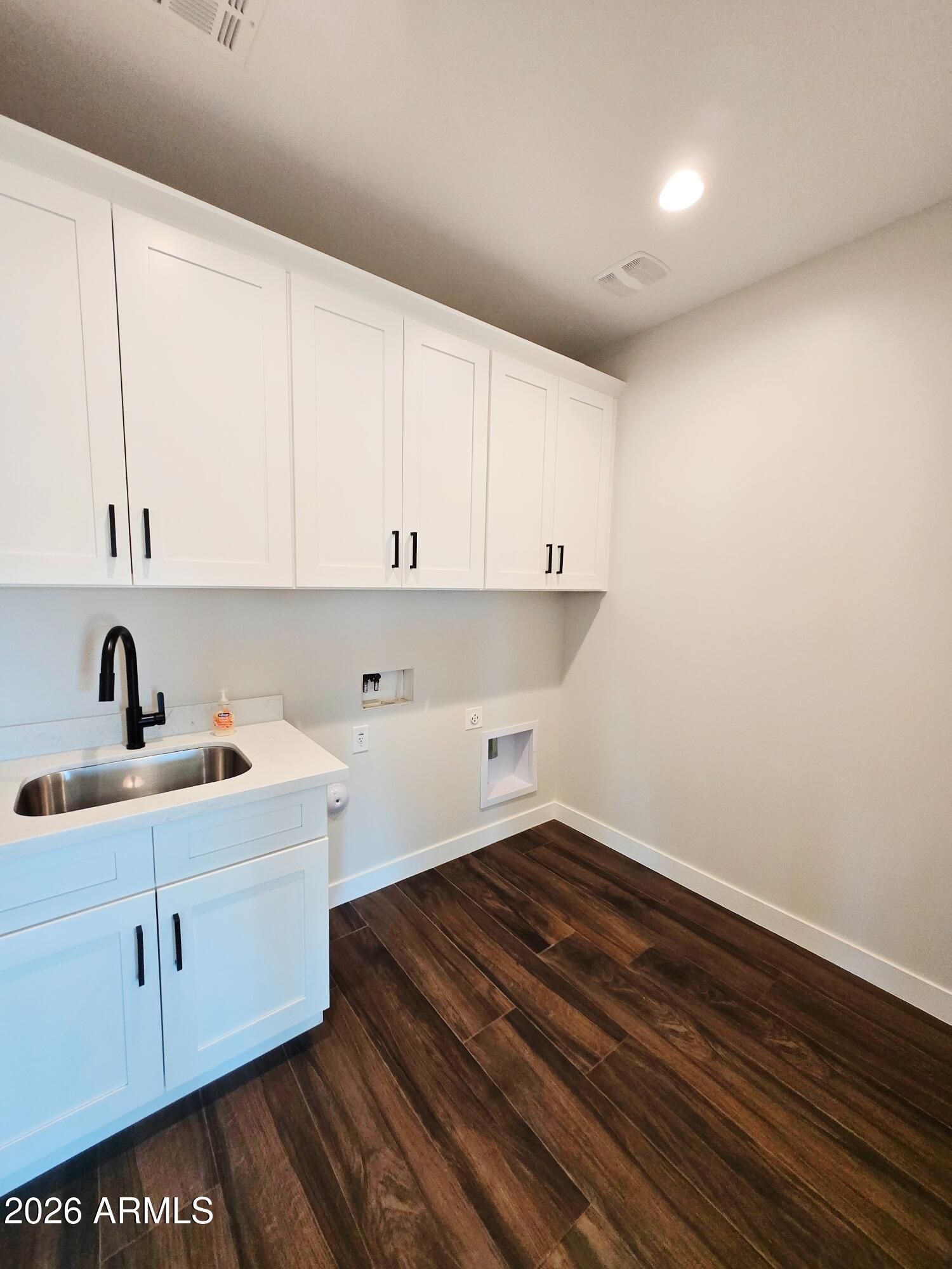 20735 West Elliot Road Buckeye, AZ 85326 - Photo 19 of 59 a view of cabinets and wooden floor