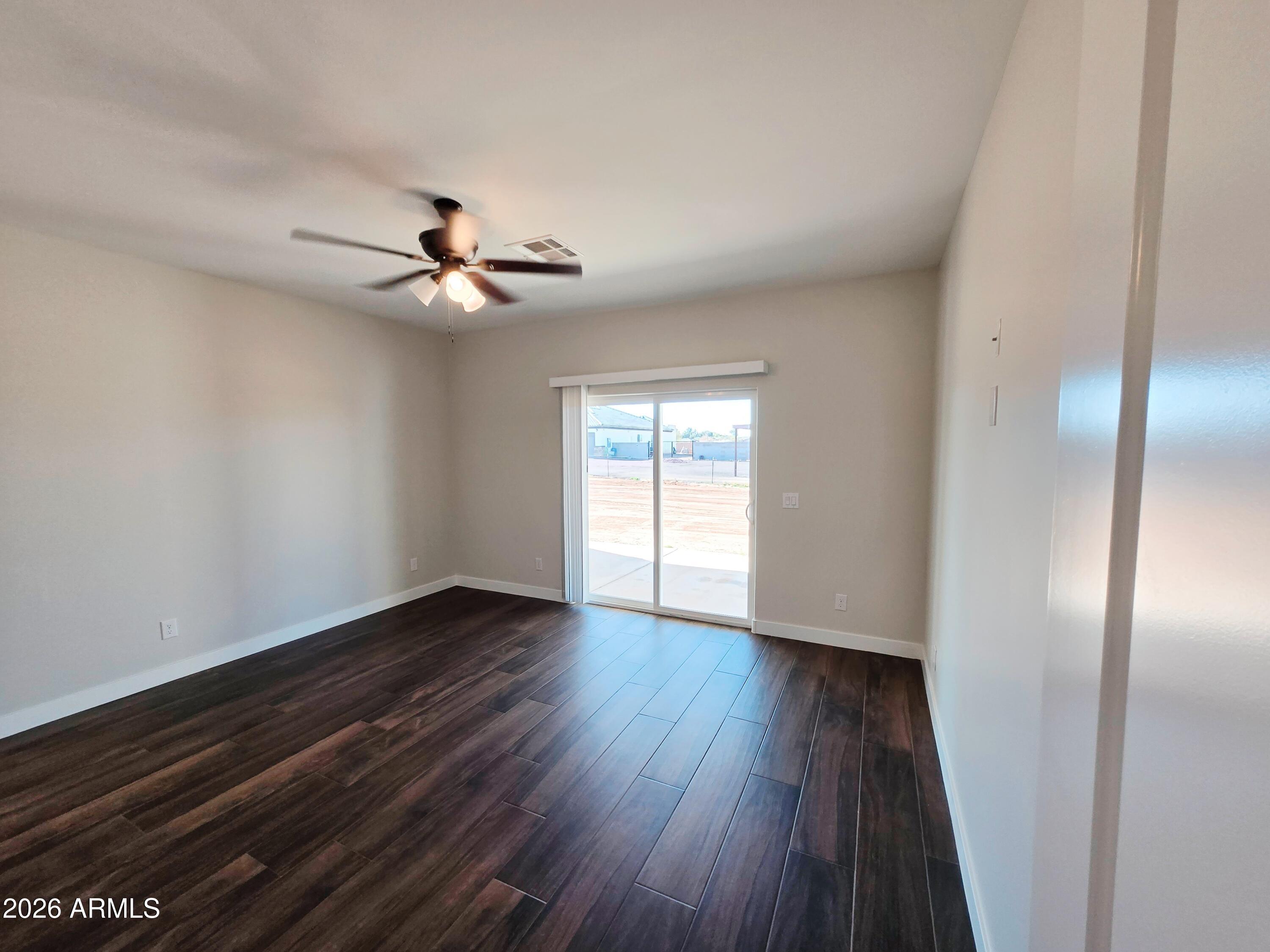 20735 West Elliot Road Buckeye, AZ 85326 - Photo 21 of 59 wooden floor in an empty room with a window