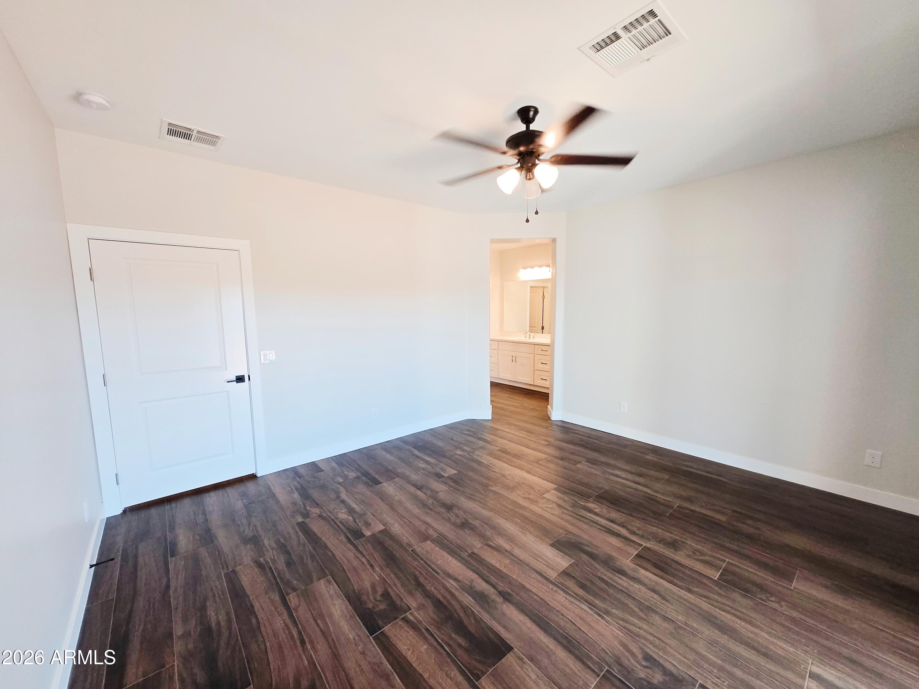 20735 West Elliot Road Buckeye, AZ 85326 - Photo 23 of 59 a view of an empty room and wooden floor