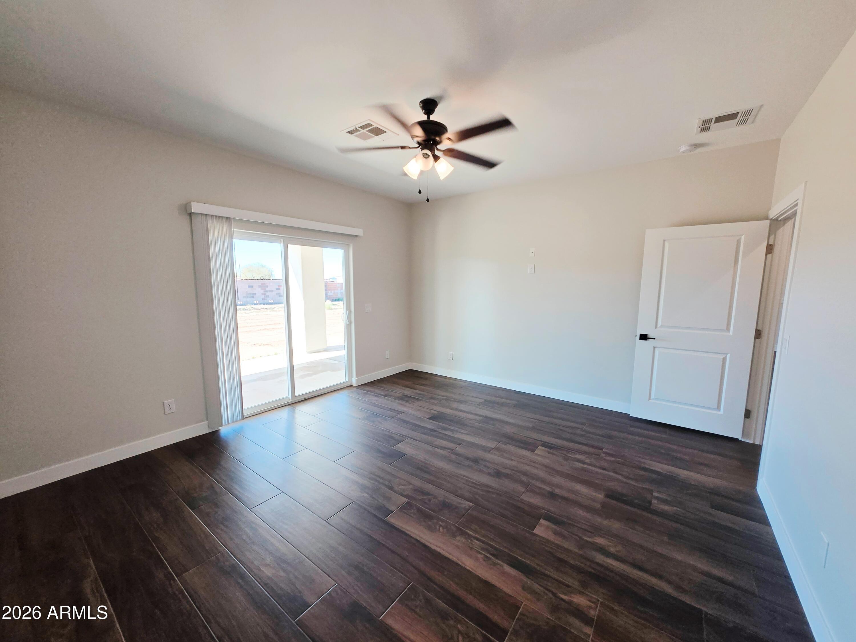 20735 West Elliot Road Buckeye, AZ 85326 - Photo 24 of 59 wooden floor in an empty room with a window