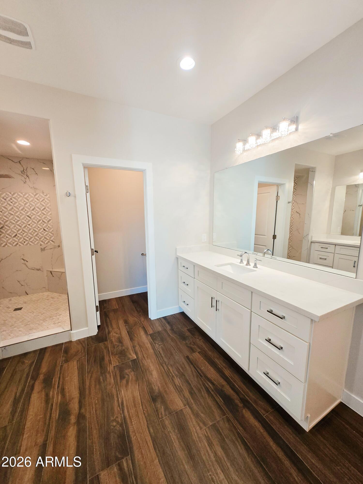 20735 West Elliot Road Buckeye, AZ 85326 - Photo 27 of 59 a spacious bathroom with a double vanity sink and a mirror