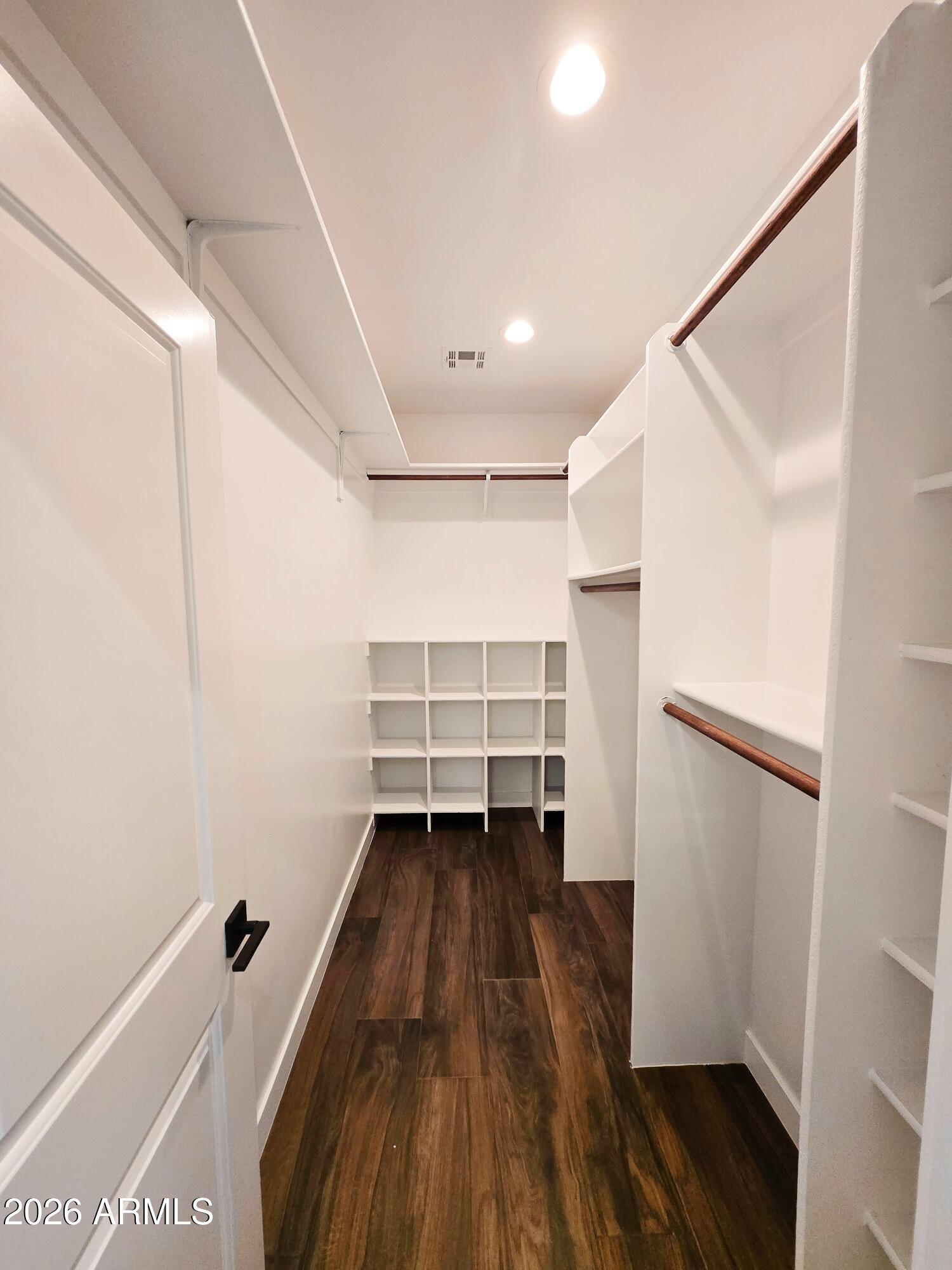 20735 West Elliot Road Buckeye, AZ 85326 - Photo 28 of 59 a view of walk in closet with wooden floor