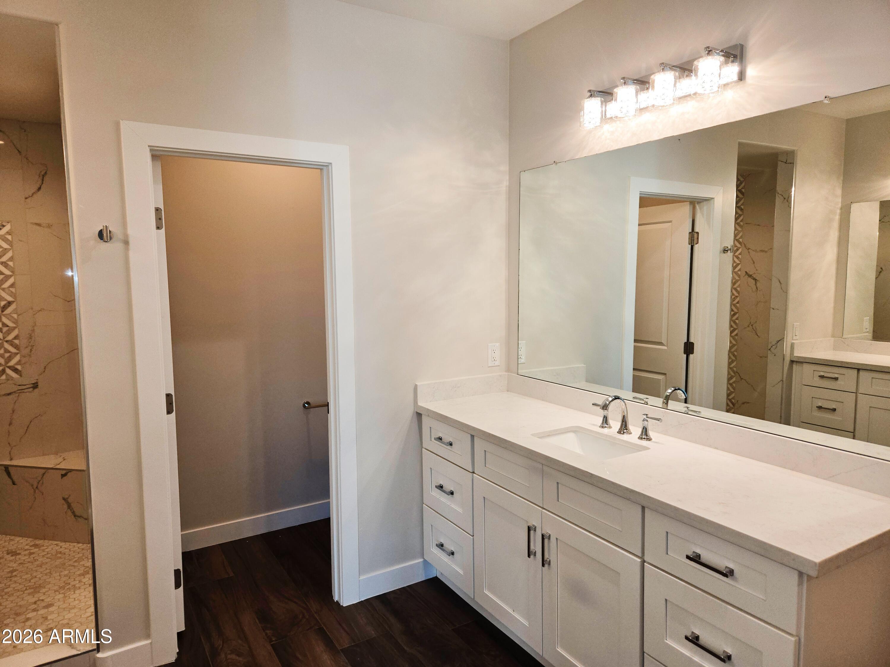 20735 West Elliot Road Buckeye, AZ 85326 - Photo 29 of 59 a bathroom with a double vanity sink and a mirror
