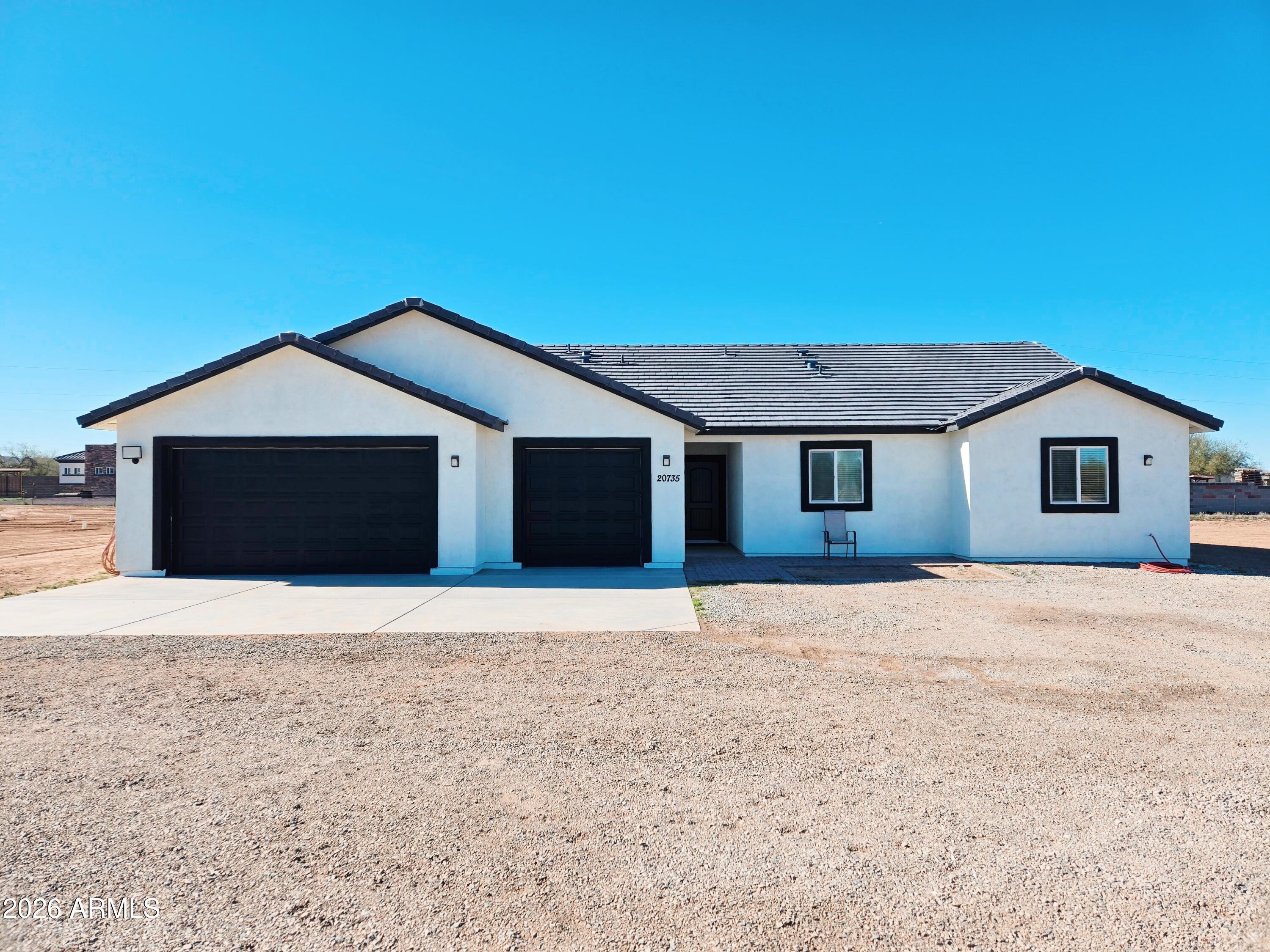 20735 West Elliot Road Buckeye, AZ 85326 - Photo 2 of 59 a front view of a house with a yard