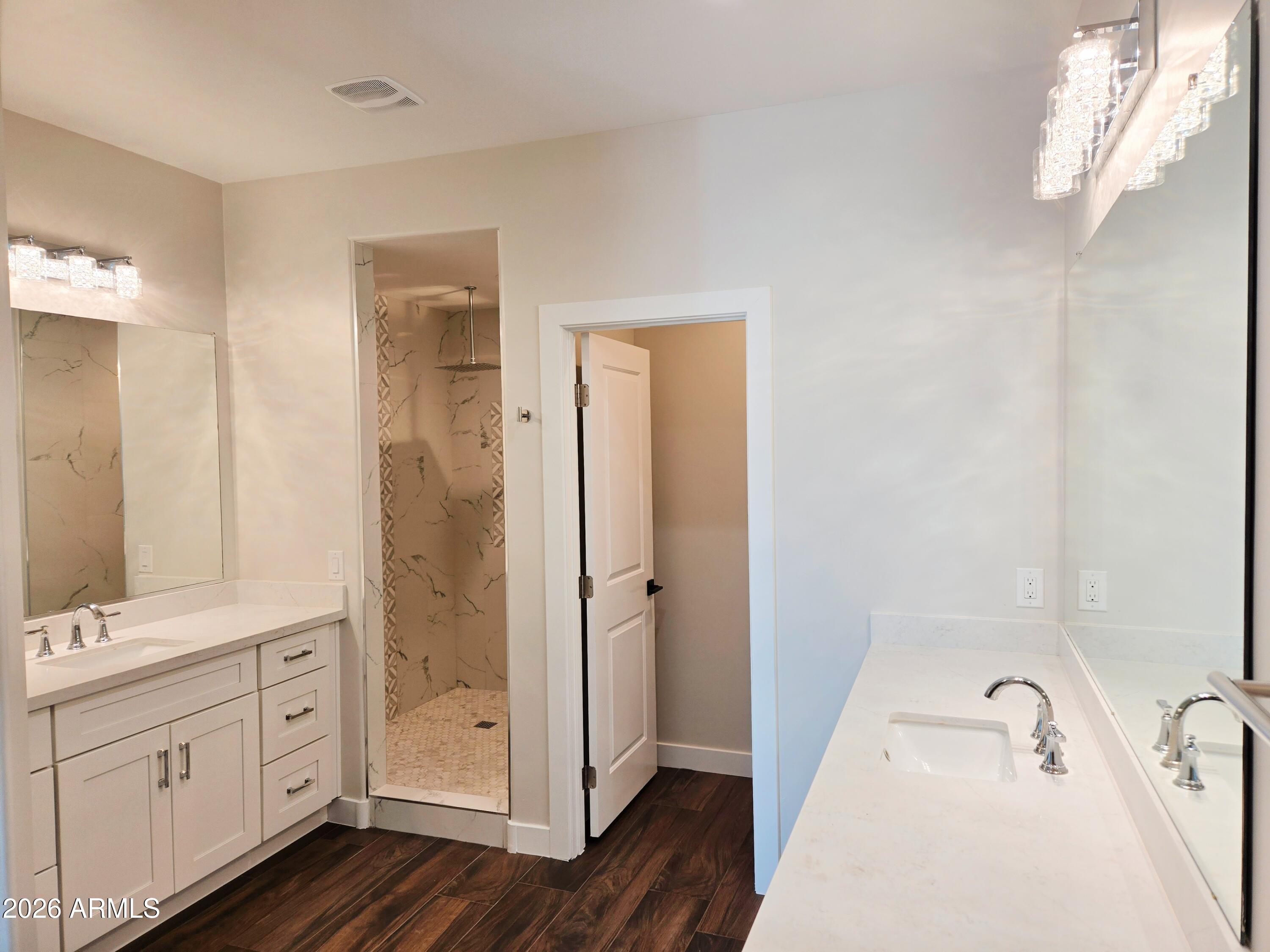 20735 West Elliot Road Buckeye, AZ 85326 - Photo 30 of 59 a bathroom with a tub sink and shower