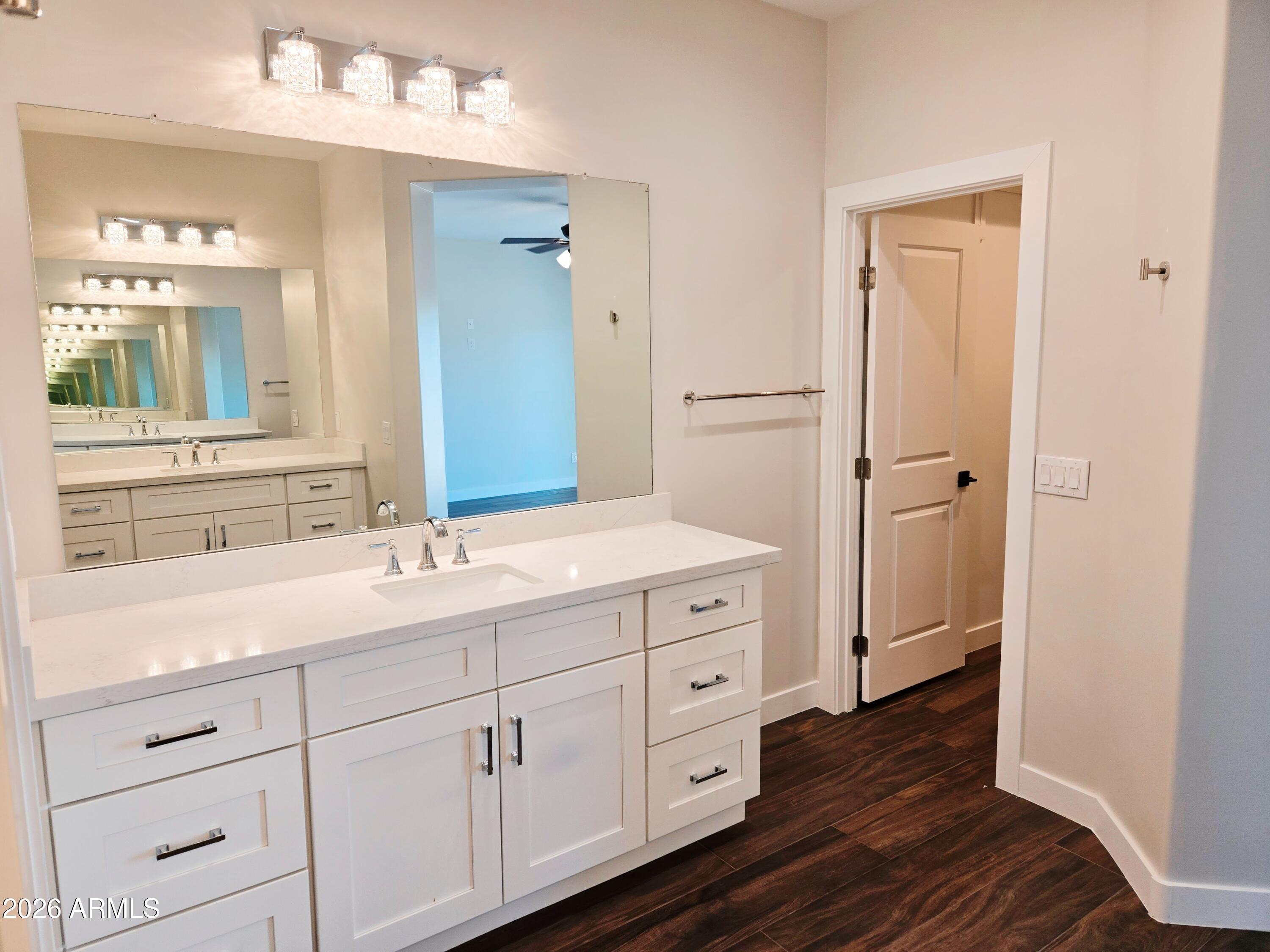 20735 West Elliot Road Buckeye, AZ 85326 - Photo 31 of 59 a bathroom with a double vanity sink and mirror