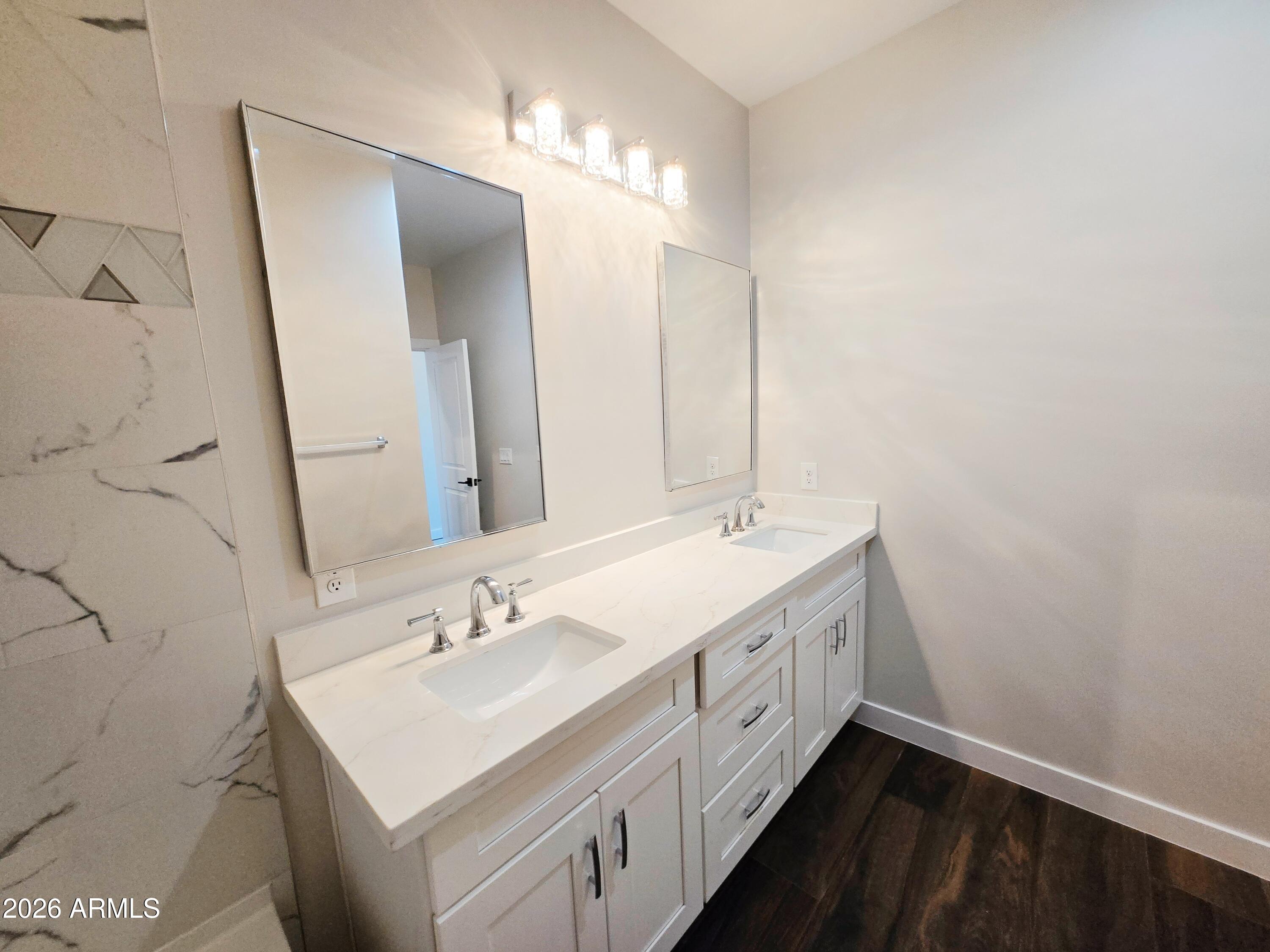 20735 West Elliot Road Buckeye, AZ 85326 - Photo 37 of 59 a bathroom with a double vanity sink and a mirror