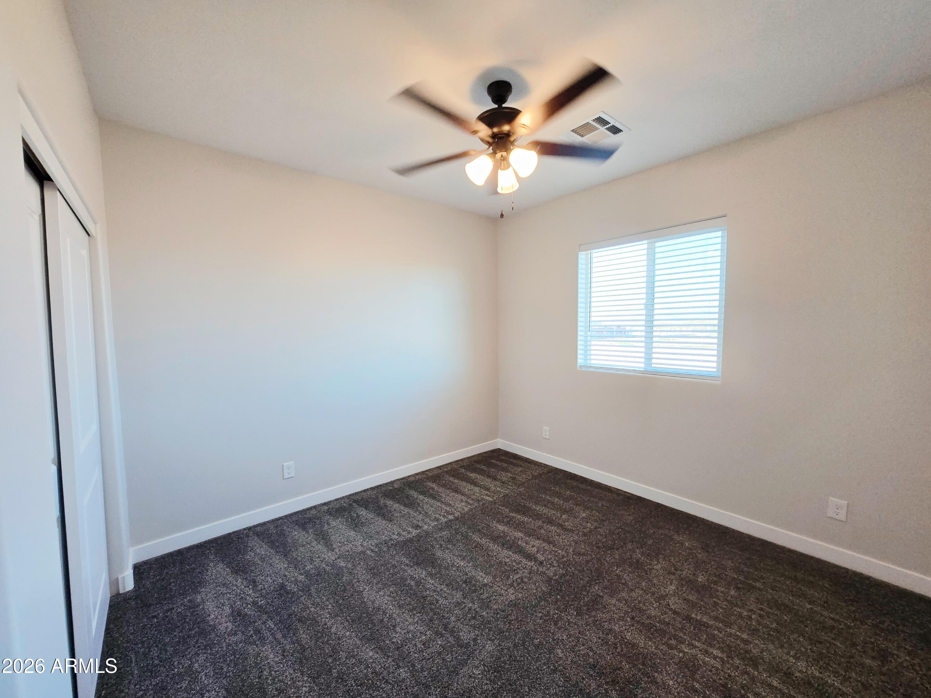 20735 West Elliot Road Buckeye, AZ 85326 - Photo 39 of 59 an empty room with windows and fan