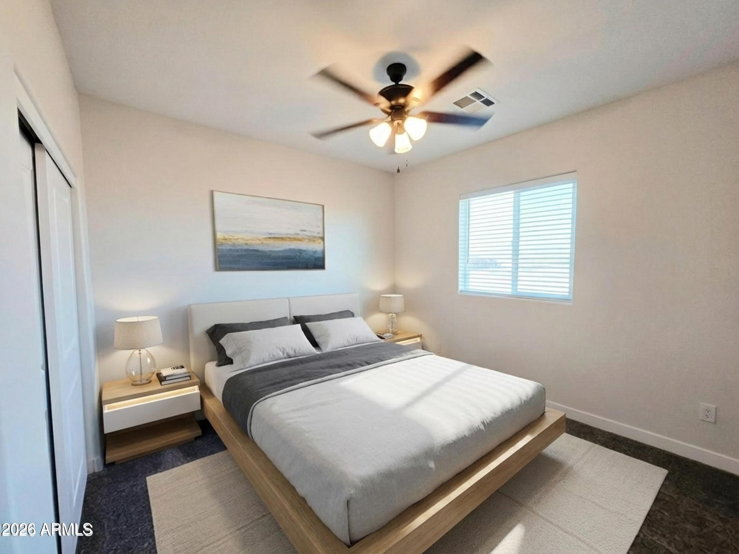 20735 West Elliot Road Buckeye, AZ 85326 - Photo 40 of 59 a bedroom with a large bed and a chandelier