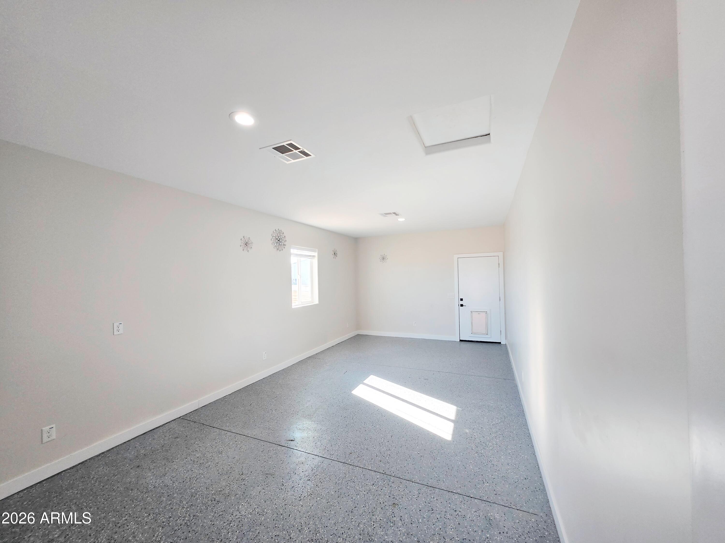 20735 West Elliot Road Buckeye, AZ 85326 - Photo 41 of 59 an empty room with a empty space and windows