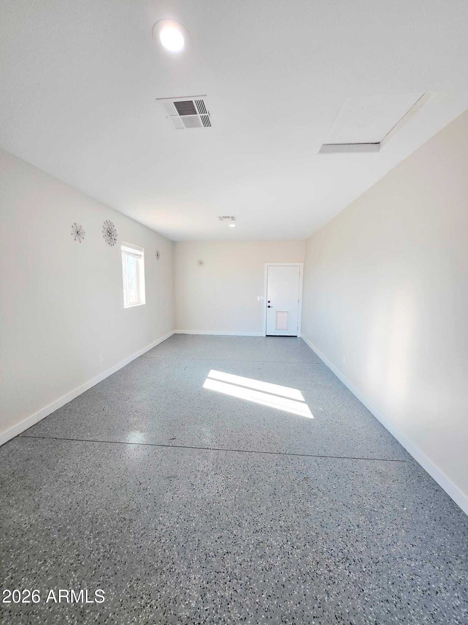 20735 West Elliot Road Buckeye, AZ 85326 - Photo 43 of 59 an empty room with a empty space and windows